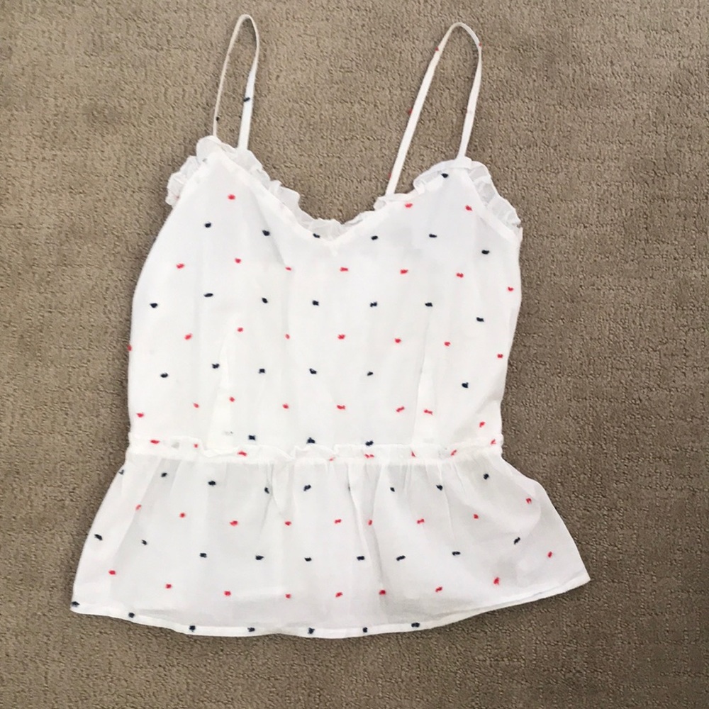 White tank top blouse with embroidered blue and red polka dots.